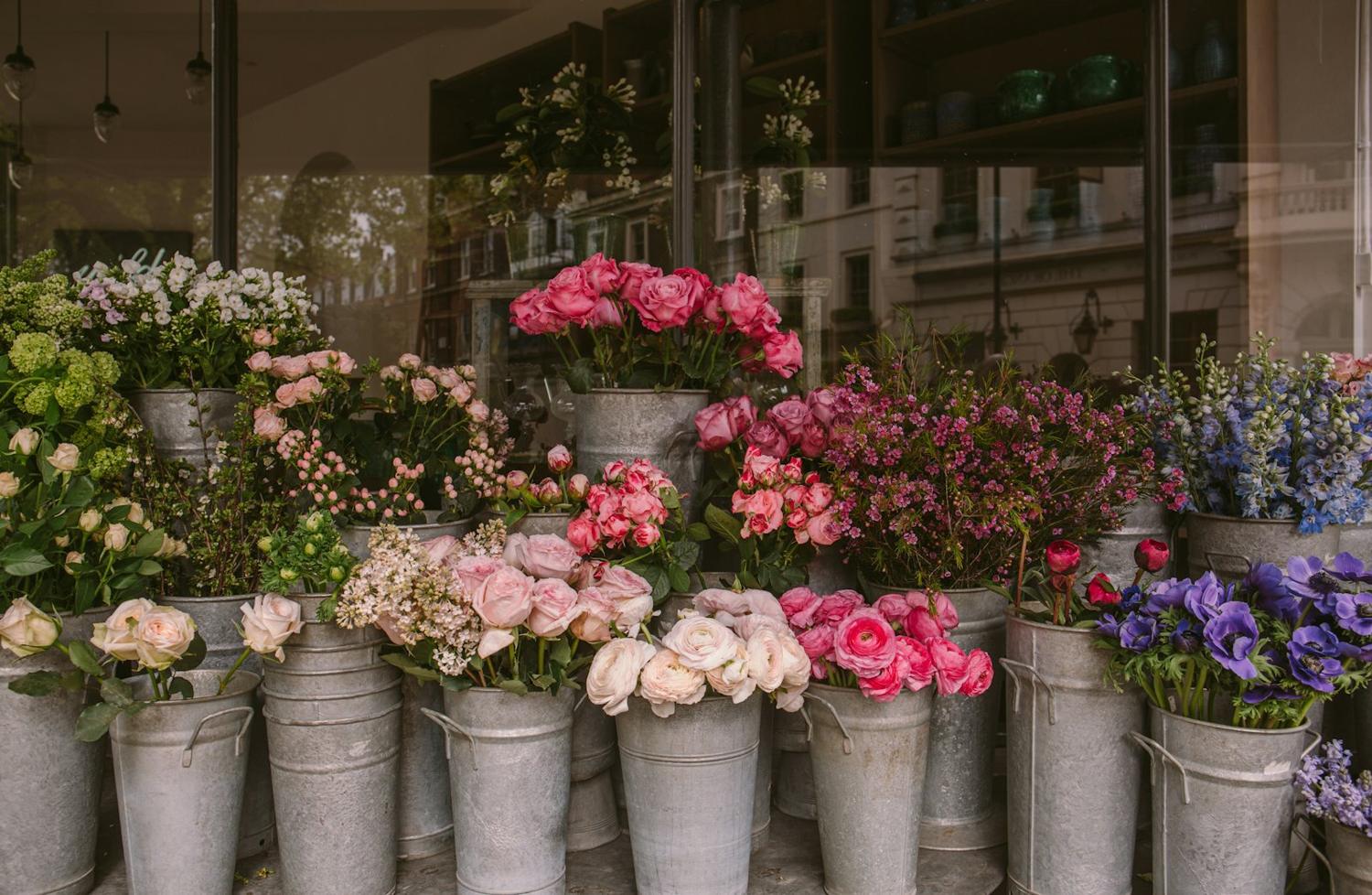 A flower shop with buckets of blooms